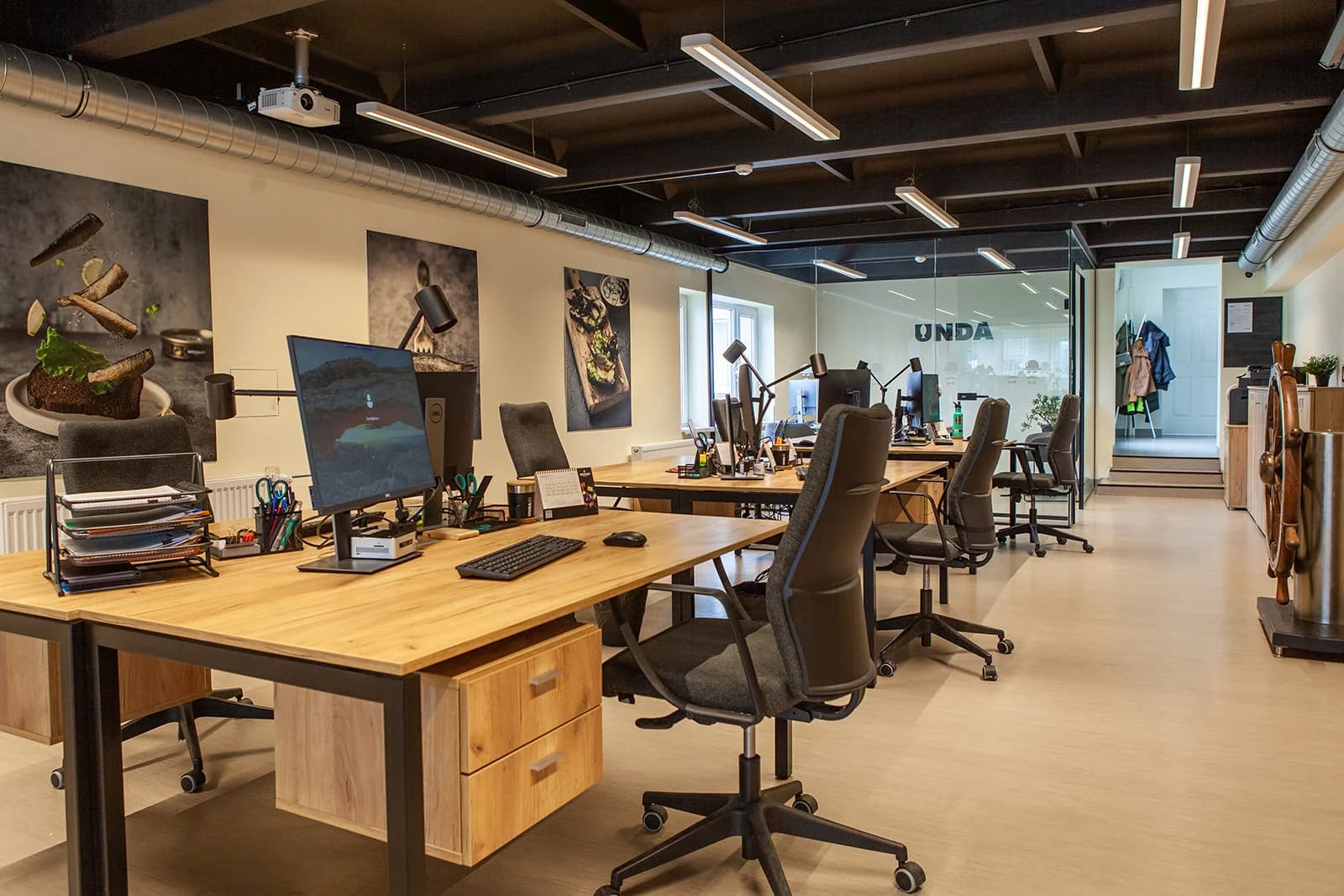 SIA Unda office with shared desks and glass meeting-room partitions
