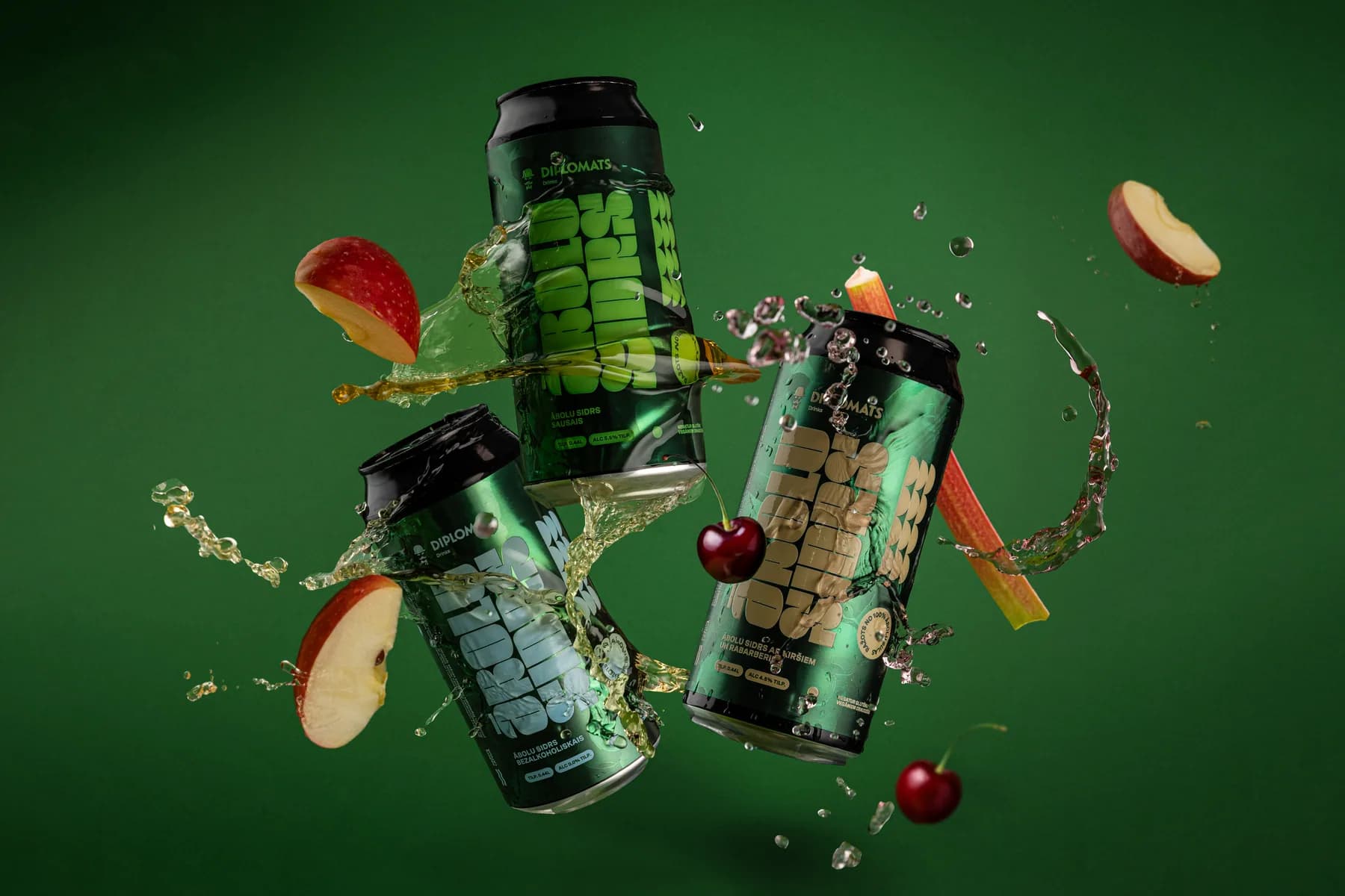 Diplomats drinks with apple, carrot and cherry ingredients against a green background