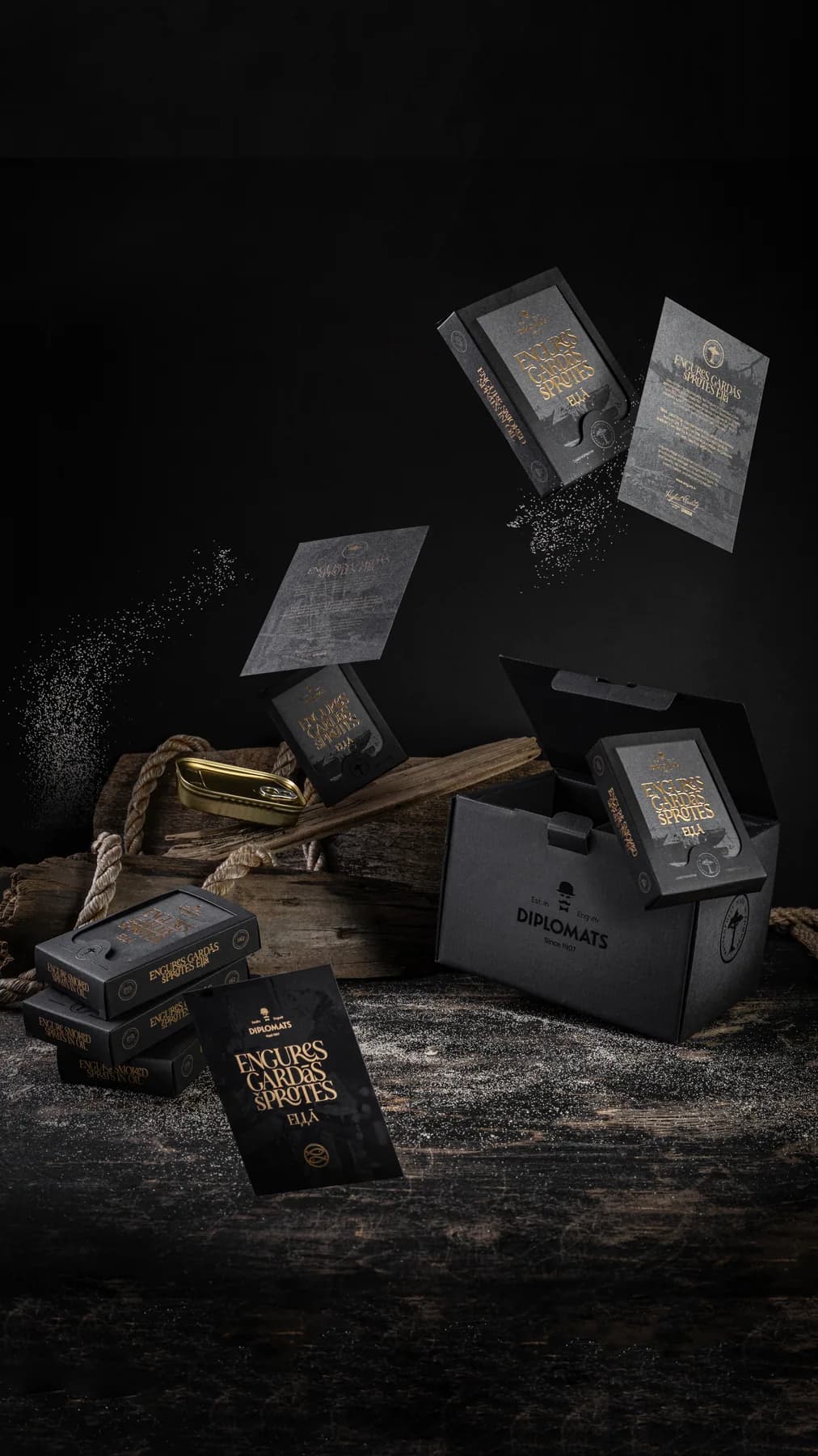 Engure sprats products arranged with wooden crates on a dark surface