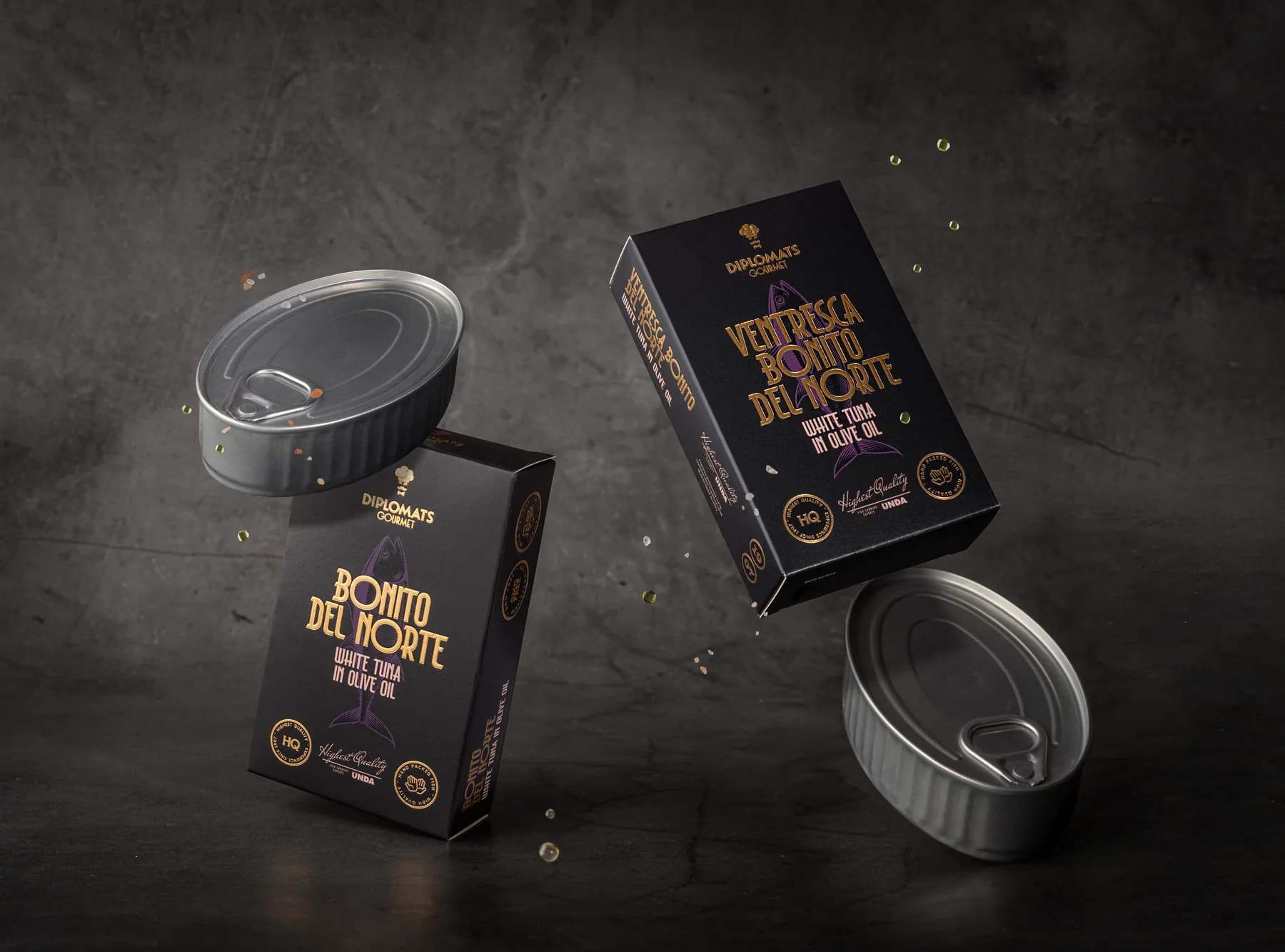 Diplomats bonito del norte tuna tins arranged on a dark surface