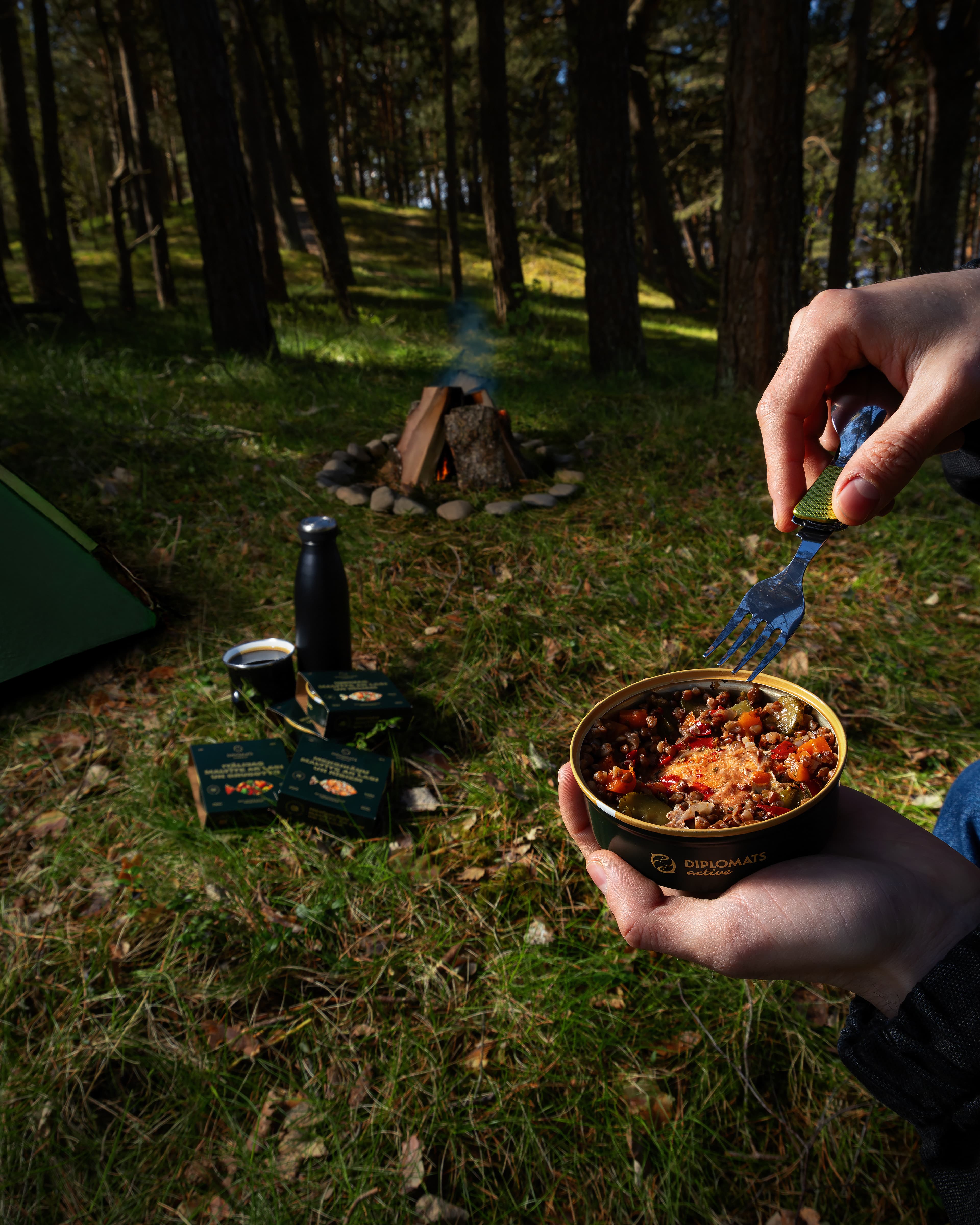 Diplomats Active ready meal enjoyed outdoors beside a campfire